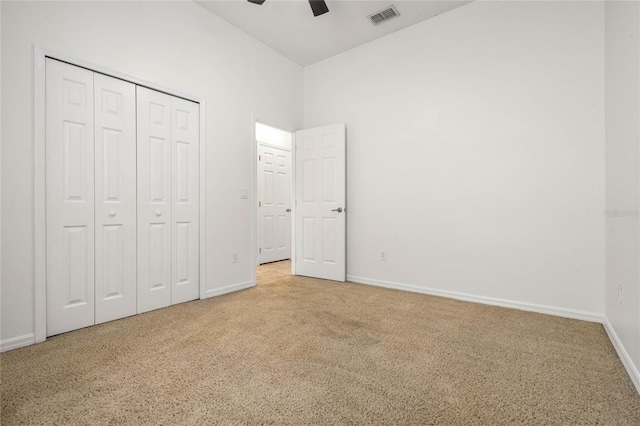 unfurnished bedroom with carpet flooring, ceiling fan, and a closet