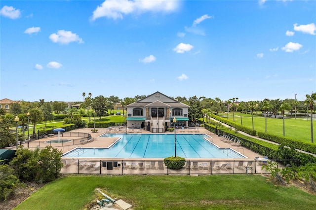 view of pool with a yard