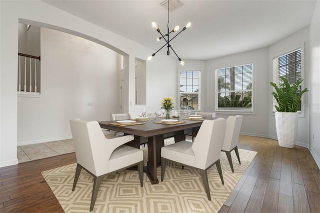 dining area featuring a notable chandelier and light wood-type flooring