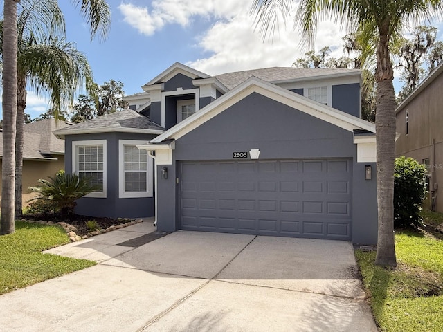 2806 Balforn Tower Way, Winter Garden, FL 34787 - traditional-style house featuring an attached garage, a shingled roof, stucco siding, and driveway