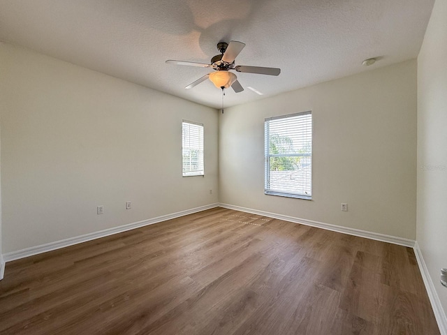 2806 Balforn Tower Way, Winter Garden, FL 34787 - empty room with dark wood finished floors, a ceiling fan, and a textured ceiling