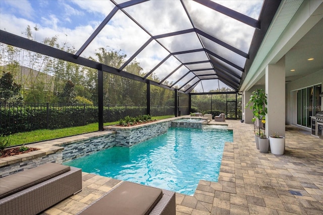 view of swimming pool featuring an in ground hot tub, a patio, and glass enclosure