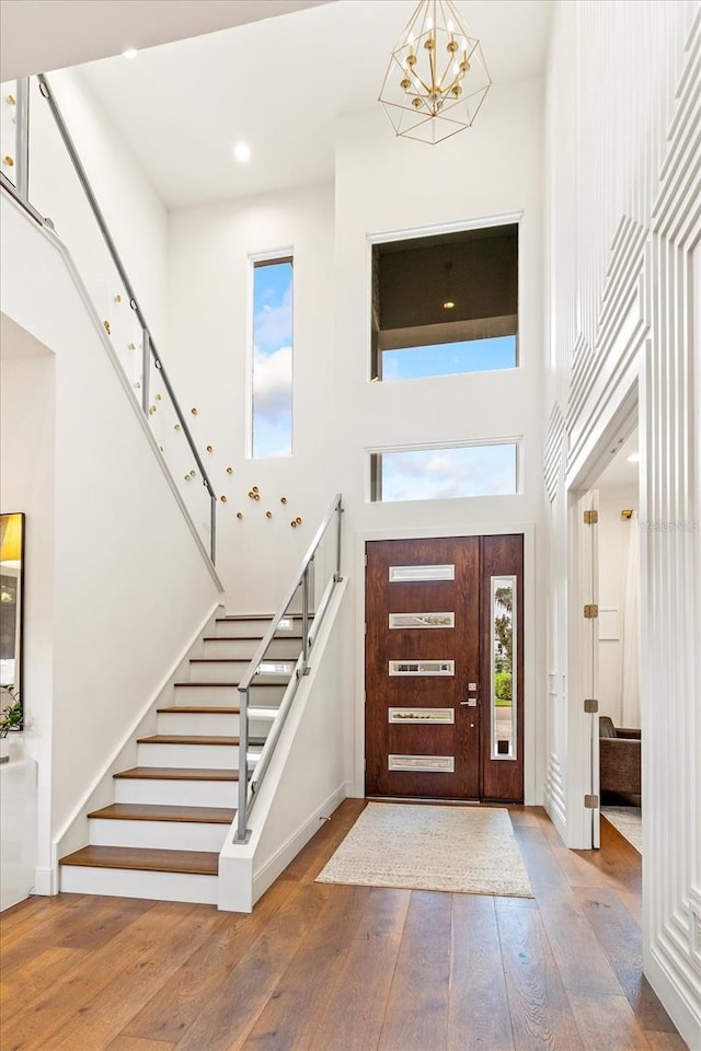 entryway with a chandelier, a high ceiling, and hardwood / wood-style floors