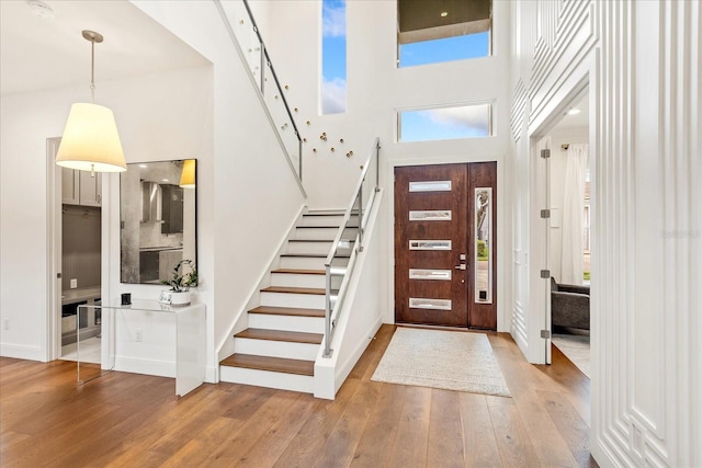 entrance foyer featuring a high ceiling and light wood-type flooring