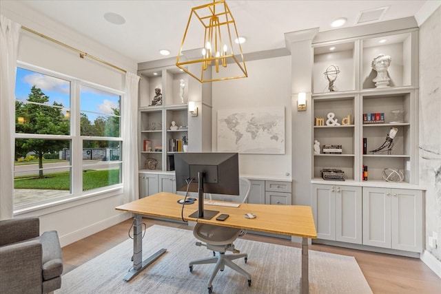 office space with a chandelier, light hardwood / wood-style floors, and a healthy amount of sunlight