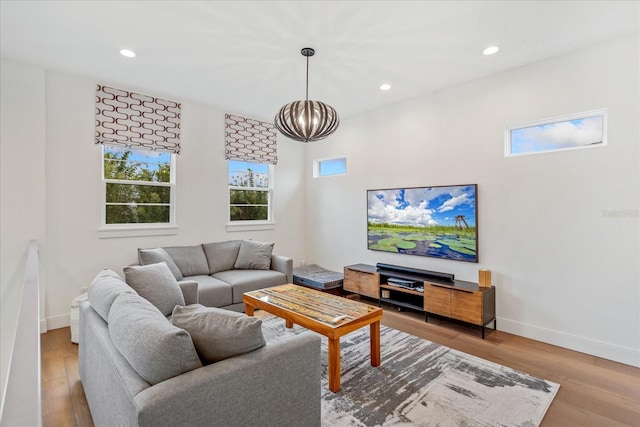 living room featuring light hardwood / wood-style flooring and a notable chandelier