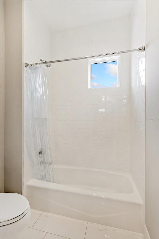 bathroom with shower / bath combo, toilet, and tile patterned floors