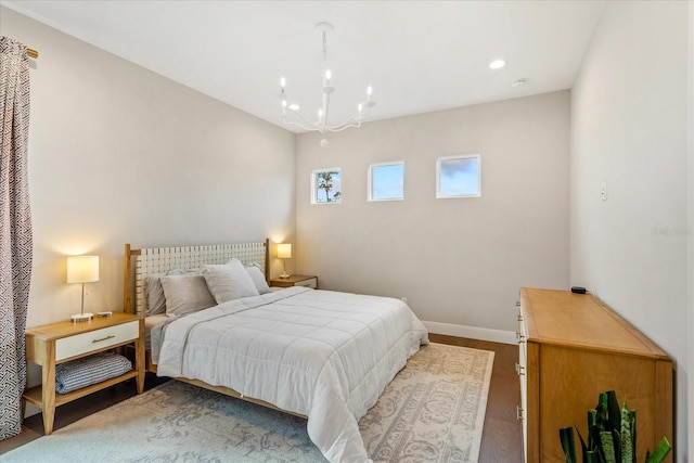 bedroom featuring a chandelier and hardwood / wood-style flooring