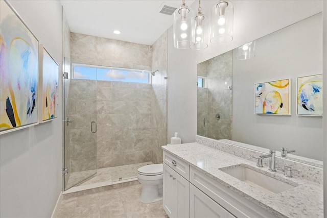 bathroom featuring tile patterned flooring, vanity, an enclosed shower, and toilet