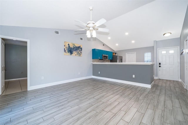 unfurnished living room with light hardwood / wood-style floors, vaulted ceiling, and ceiling fan