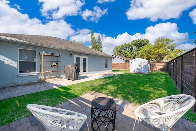 back of property featuring a lawn, a patio area, a shed, and french doors