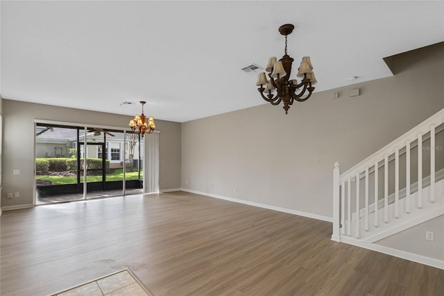 interior space featuring wood-type flooring and an inviting chandelier