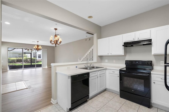 kitchen featuring sink, white cabinetry, an inviting chandelier, and black appliances