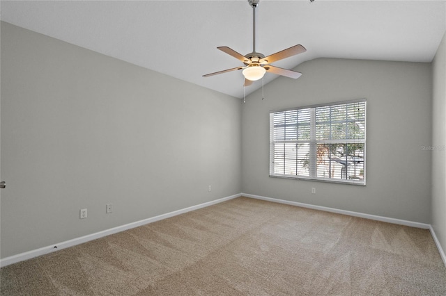 carpeted empty room with ceiling fan and vaulted ceiling