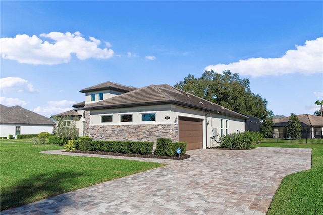 view of front facade with an attached garage, stone siding, decorative driveway, stucco siding, and a front lawn