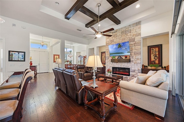 living area with dark wood-style flooring, coffered ceiling, a fireplace, and visible vents