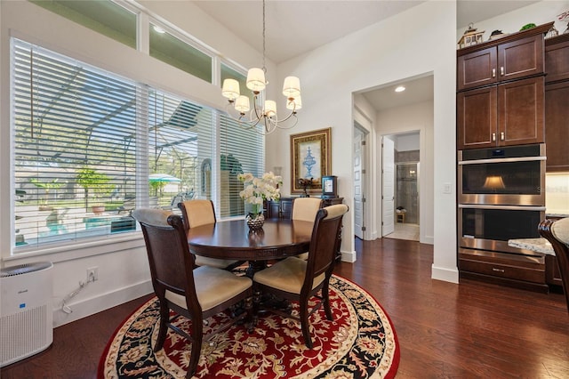 dining room with baseboards, a chandelier, and dark wood-type flooring