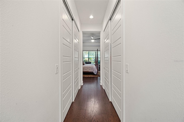 hall with dark wood-style flooring