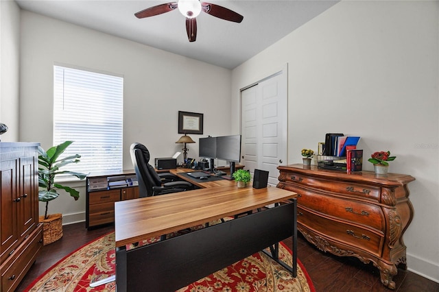 office area featuring dark wood-type flooring, baseboards, and a ceiling fan