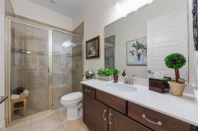 full bath featuring a stall shower, tile patterned flooring, vanity, and toilet