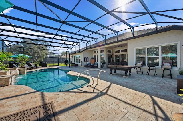 pool featuring a patio area, a lanai, and a ceiling fan