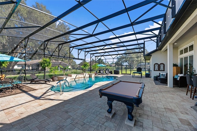 outdoor pool with a lanai, a patio area, and a hot tub