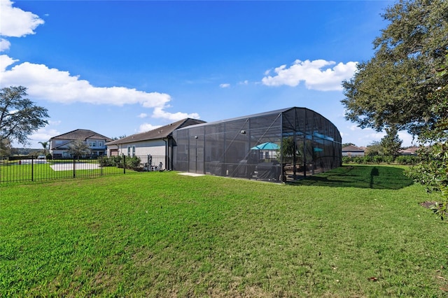 view of yard with fence and a lanai