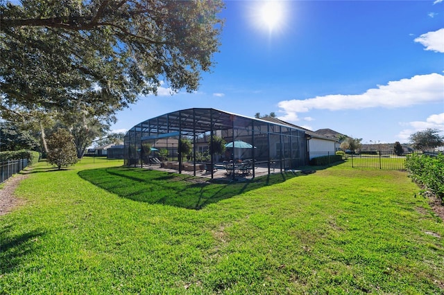 view of yard featuring a lanai, a fenced backyard, and a patio