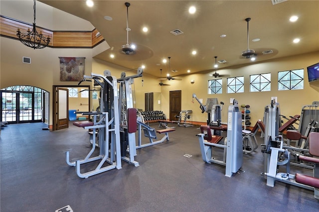 exercise room with recessed lighting, visible vents, and a towering ceiling