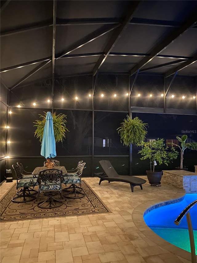 view of patio / terrace with outdoor dining area, glass enclosure, and an outdoor pool