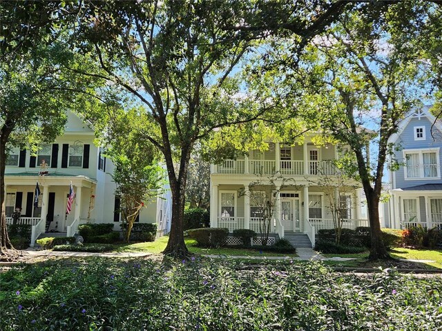 view of front of house with covered porch and a balcony