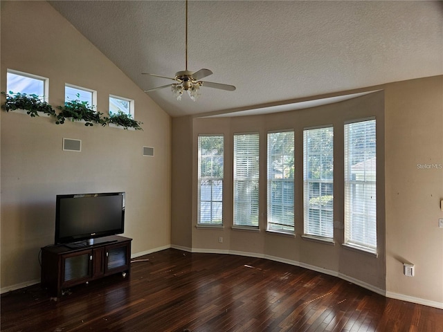 unfurnished living room with ceiling fan, dark hardwood / wood-style floors, lofted ceiling, and a textured ceiling