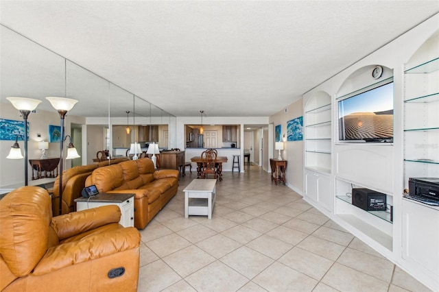 tiled living room with built in features and a textured ceiling