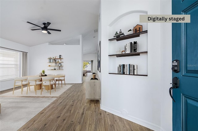 foyer with hardwood / wood-style flooring and ceiling fan