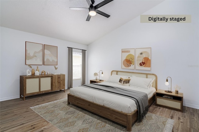 bedroom with hardwood / wood-style floors, vaulted ceiling, and ceiling fan