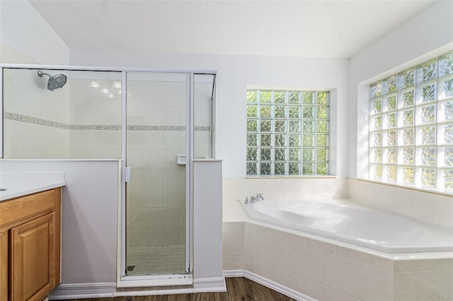 bathroom with vanity, independent shower and bath, and wood-type flooring