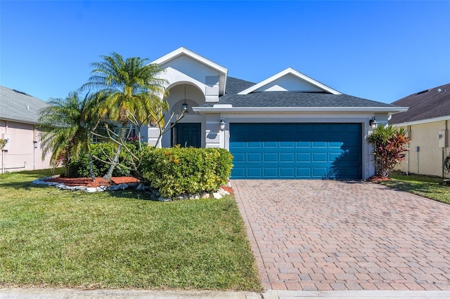 single story home featuring a garage and a front yard