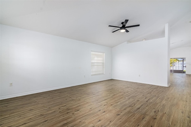 empty room with hardwood / wood-style flooring, vaulted ceiling, and ceiling fan