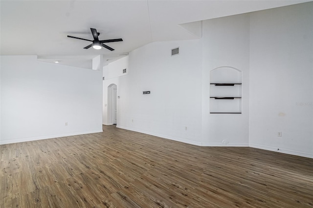 spare room featuring lofted ceiling, dark hardwood / wood-style flooring, and ceiling fan