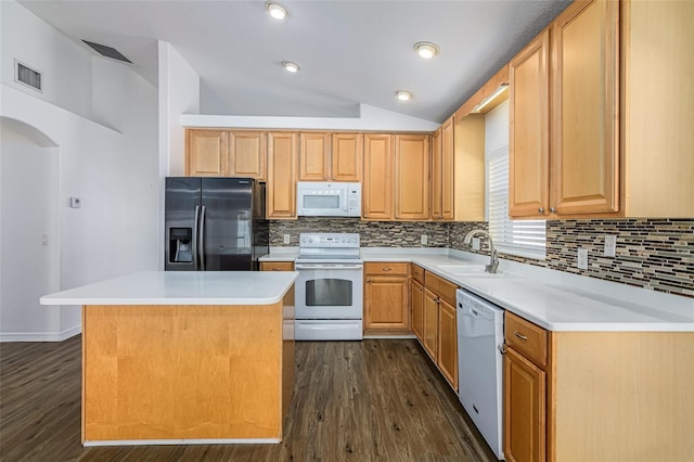 kitchen featuring sink, white appliances, dark hardwood / wood-style floors, a center island, and vaulted ceiling