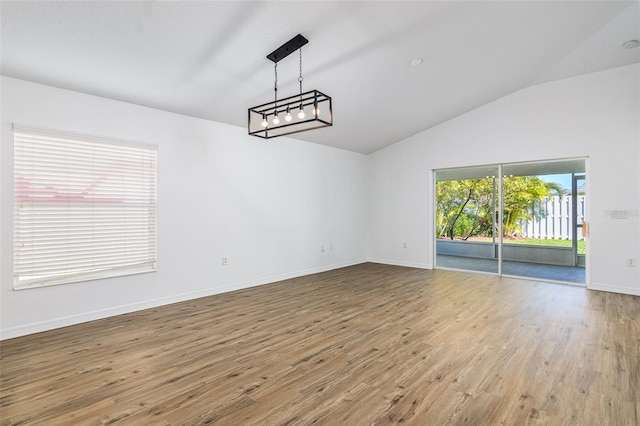 interior space featuring wood-type flooring and vaulted ceiling