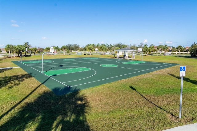 view of sport court with a lawn