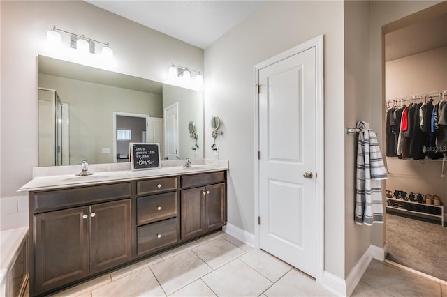 bathroom with tile patterned floors, vanity, and a shower with shower door