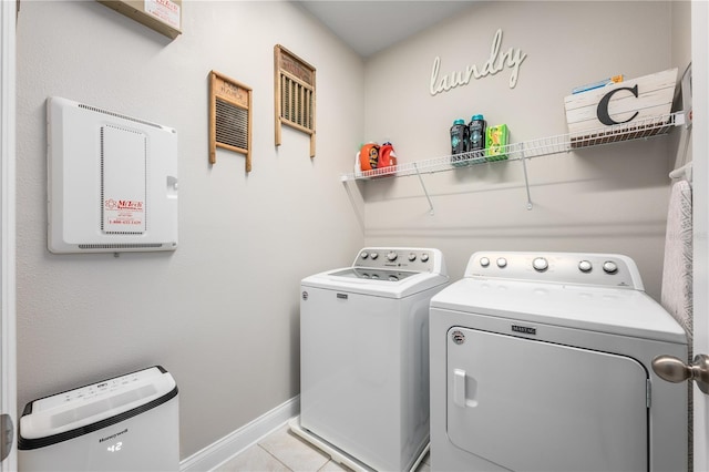 washroom with washing machine and dryer and light tile patterned floors