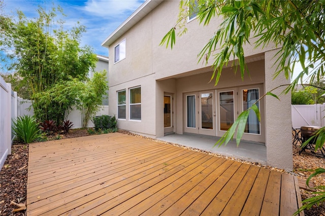 wooden deck featuring a patio and french doors