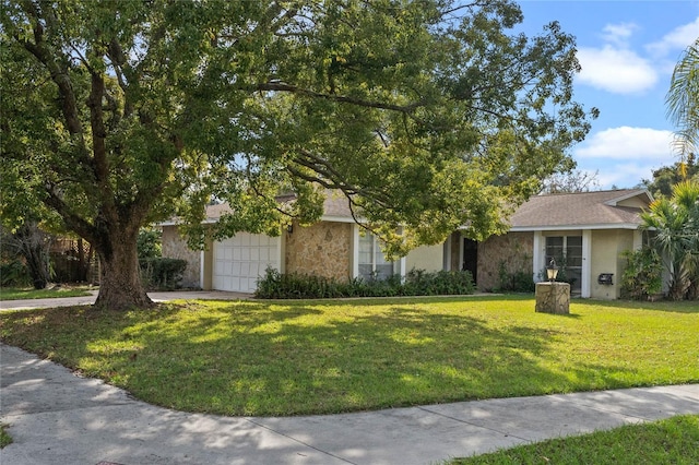 view of front of home with a garage and a front lawn