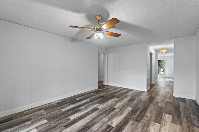 spare room with dark hardwood / wood-style flooring, ceiling fan with notable chandelier, and a textured ceiling