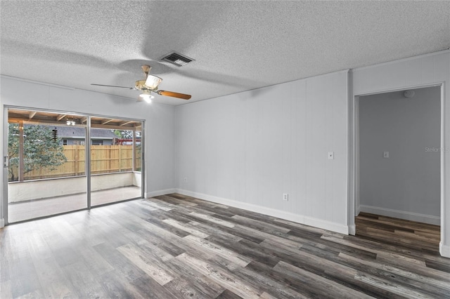 unfurnished room featuring ceiling fan, dark hardwood / wood-style flooring, and a textured ceiling