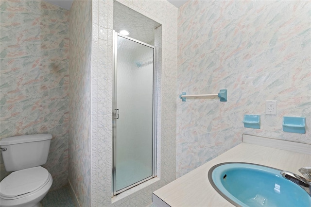 bathroom with tile patterned flooring, toilet, vanity, and walk in shower