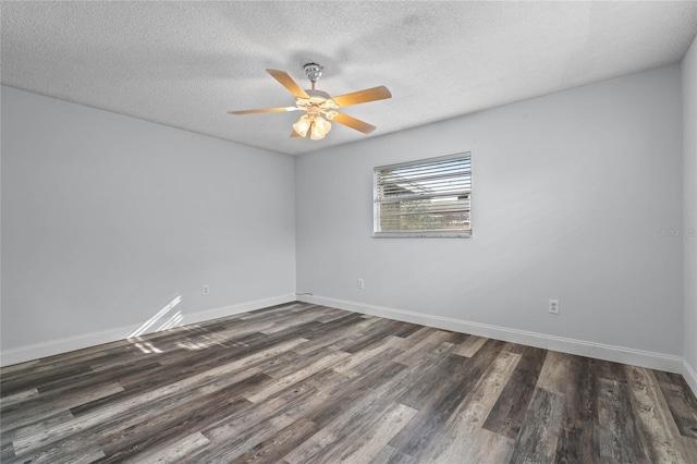 unfurnished room featuring a textured ceiling and dark hardwood / wood-style floors